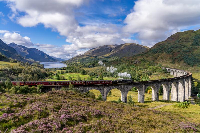  Zug fährt auf der Glenfinnan Brücke bei eurer Familienreise Schottland