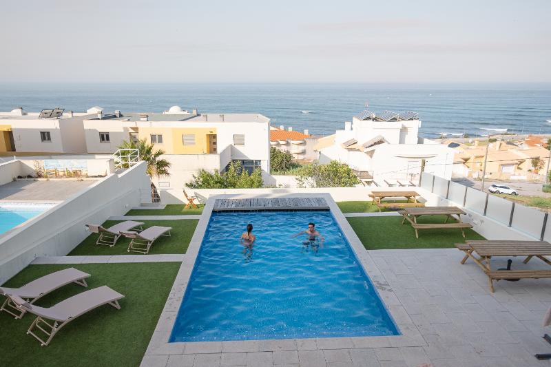 Blick vom Balkon auf den Pool und das Meer im Familienurlaub Surfen