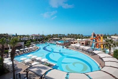 Großer Pool und bunte Rutschen mit schattigen Liegen im Familienurlaub Türkei