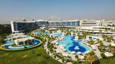 Große Hotelanlage mit mehreren Pools, umrandet von Palmen im Familienurlaub Türkei