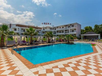 Poolanlage mit gemütlichen Daybeds und kleinem Hotelgebäude im Familienurlaub Kreta