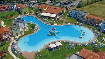 Geschwungener Pool mit Kinderbadebereich und Wiese im Familienurlaub Italien