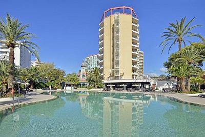 Pool und dahinter mehrstöckiges Hotelgebäude im Familienurlaub Mallorca