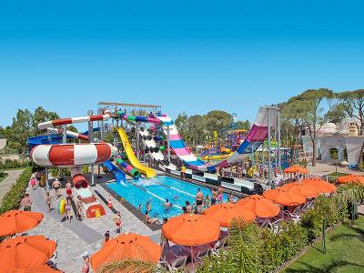 Viele bunte Wasserrutschen und orangene Schirme im Familienurlaub Türkei